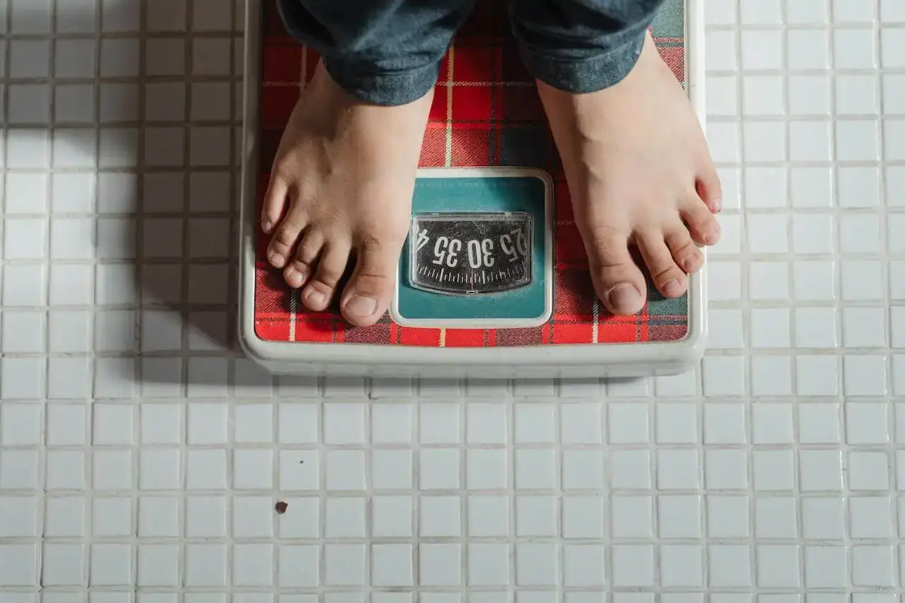 Person weighing himself on a scale